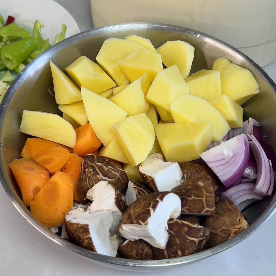 Cho nấm hương vào đảo đều cho ngấm gia vị rồi thêm nước sôi, hầm khoảng 30 phút. Sau 20 phút, cho cà rốt và khoai tây vào hầm thêm 10 phút.